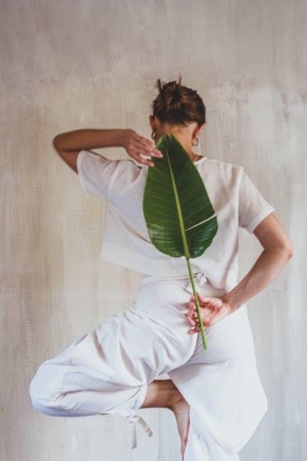 Woman performing a graceful back stretch yoga pose in nature.